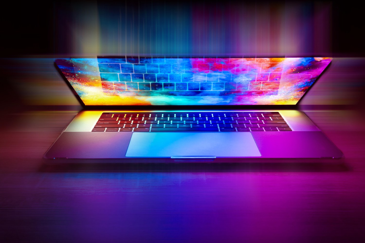 Laptop illuminated with colourful digital light