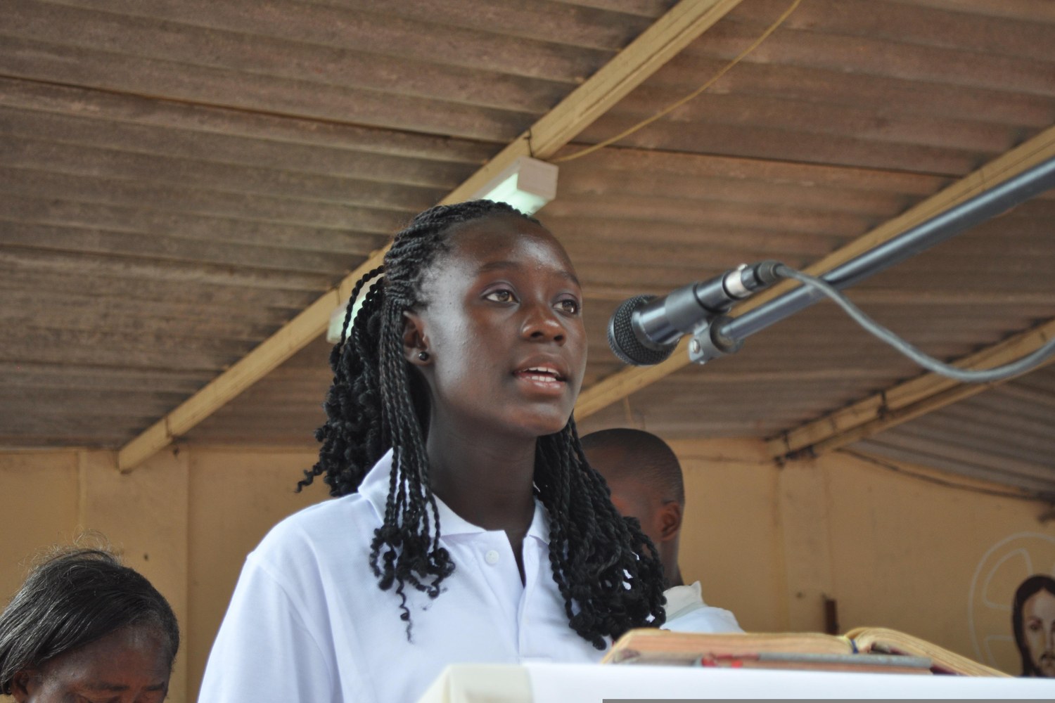 Student speaking at a lectern during a moot-style presentation